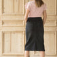 Woman wearing a modest black denim skirt that falls below the knee