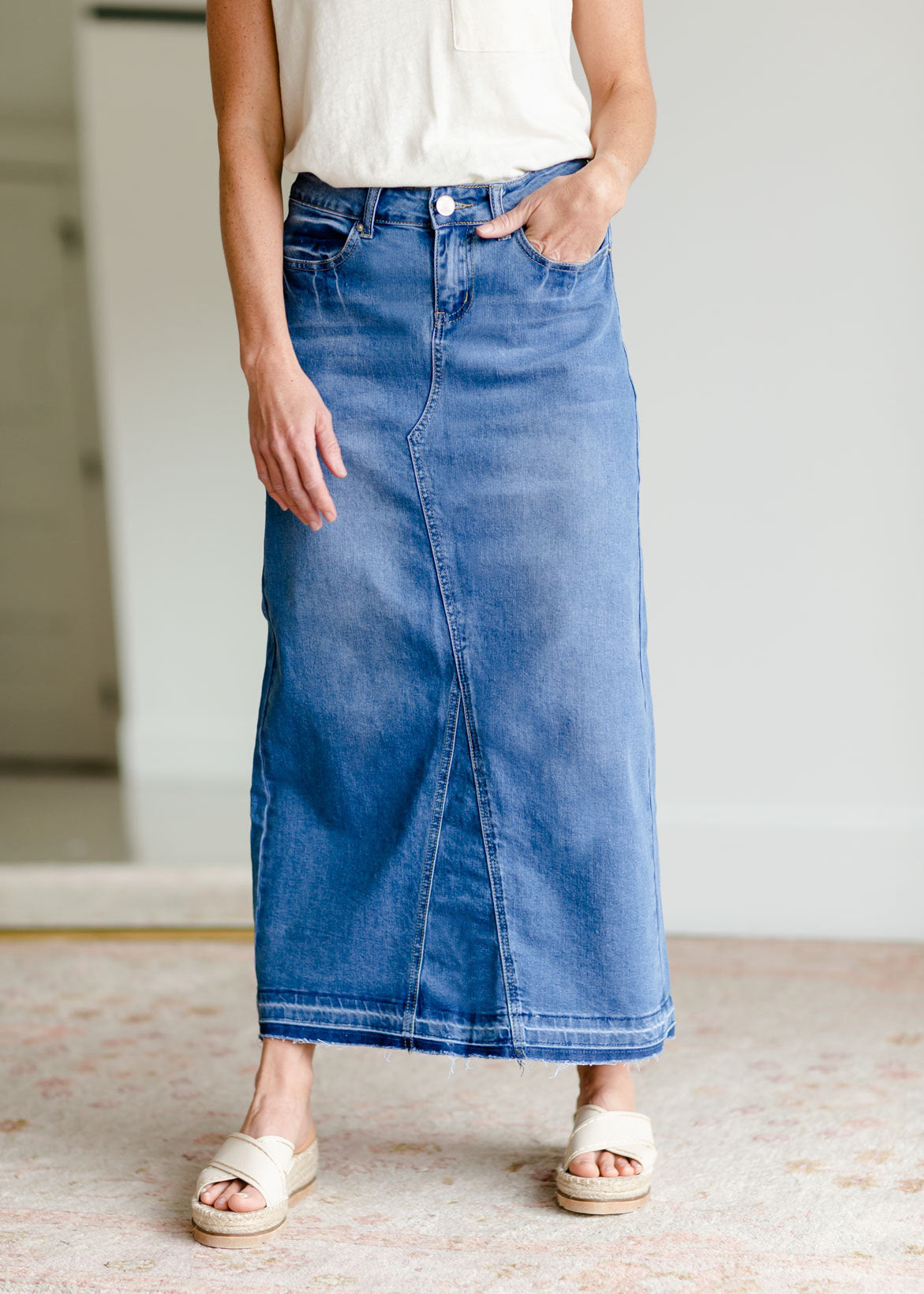 The Stacy skirt is long denim with a raw hem and slight monkey washing in a medium wash. This is an inherit designed long denim mdest skirt.