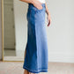The Stacy skirt is long denim with a raw hem and slight monkey washing in a medium wash. This is an inherit designed long denim mdest skirt.
