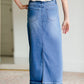 The Stacy skirt is long denim with a raw hem and slight monkey washing in a medium wash. This is an inherit designed long denim mdest skirt.