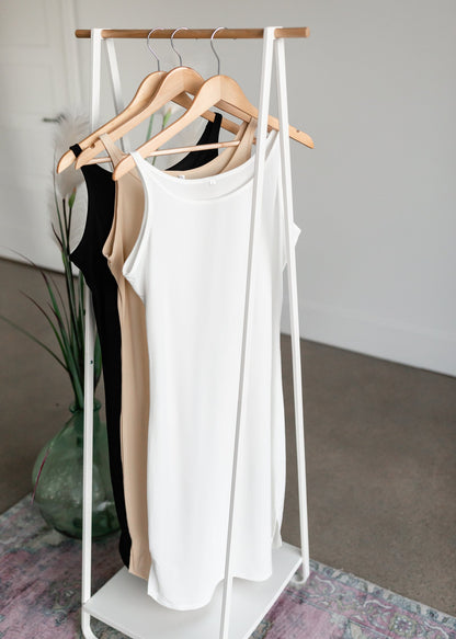 Women's Full Slip Dresses InheritPerfect for layering under dresses, this modest full slip will be a closet staple. It features a rounded bottom hem with a scalloped side edge, a modest neckline, and tank top style straps.