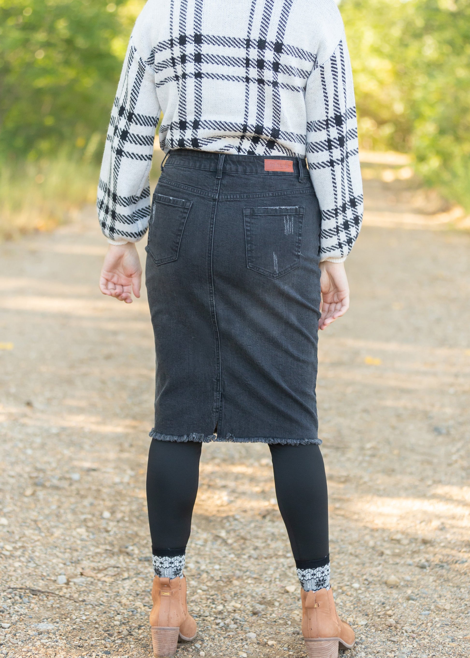 Crafted from a cotton blend, this Zoey Frayed Hem Black Denim Midi Skirt is an Inherit Design you'll be reaching for again and again! This skirt has an on-trend, yet classic style to it. There is slight distressing and the raw hem is the perfect finishing touch!